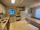 Bright kitchen with a window and white cabinets offering a functional cooking area at 1408 Torrey Pines Dr, Lady Lake, FL 32159