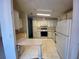 Functional kitchen with white cabinets and standard appliances offers a practical cooking space at 1408 Torrey Pines Dr, Lady Lake, FL 32159