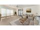 Bright living room with neutral carpet, ceiling fan, and sliding glass doors to an enclosed lanai at 1408 Torrey Pines Dr, Lady Lake, FL 32159