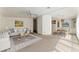Open-concept living room and dining area with neutral carpet and a view of the kitchen at 1408 Torrey Pines Dr, Lady Lake, FL 32159