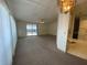 Open-concept living area with carpet, sliding doors to a patio, and access to the kitchen at 1408 Torrey Pines Dr, Lady Lake, FL 32159