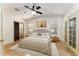 Bedroom with ceiling fan, walk-in closet, and access to bathroom at 1408 Torrey Pines Dr, Lady Lake, FL 32159