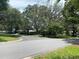A residential street is lined with many trees and houses at 1408 Torrey Pines Dr, Lady Lake, FL 32159