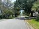 Scenic street view with mature trees and well-maintained homes in a peaceful neighborhood at 1408 Torrey Pines Dr, Lady Lake, FL 32159