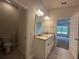 Bathroom with double sink, granite counters, and large mirror at 15106 Se 94Th Ter, Summerfield, FL 34491