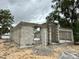 The grey block walls of the partially constructed home show window and door openings at a construction site at 15106 Se 94Th Ter, Summerfield, FL 34491