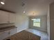 Kitchen with granite counters, stainless appliances, and views to backyard at 15106 Se 94Th Ter, Summerfield, FL 34491