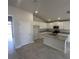 Bright kitchen features granite counters, white cabinets, and stainless steel appliances at 15106 Se 94Th Ter, Summerfield, FL 34491