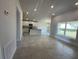 Spacious living room with tile floors and an open view into the kitchen and dining area at 15106 Se 94Th Ter, Summerfield, FL 34491