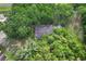 An aerial shot of a house surrounded by tall, mature trees at 16120 Nw Us Highway 27, Williston, FL 32696