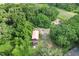 An aerial view of a rural property with a barn and surrounding trees at 16120 Nw Us Highway 27, Williston, FL 32696