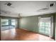 Bedroom featuring hardwood floors, natural light, and access to a screened patio at 16120 Nw Us Highway 27, Williston, FL 32696