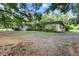A brick single story home showing the front yard and mature trees at 16120 Nw Us Highway 27, Williston, FL 32696