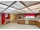 Retro kitchen with wood cabinets, fireplace, and lots of natural light at 16120 Nw Us Highway 27, Williston, FL 32696