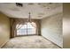 This living room features a large window with curtains and a chandelier at 16120 Nw Us Highway 27, Williston, FL 32696