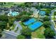 Aerial view highlighting the community pool, tennis courts, and surrounding residential area in a lush, green setting at 16193 Sw 14Th Avenue Rd, Ocala, FL 34473