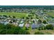 Aerial view of a neighborhood with houses bordering a well-maintained golf course at 16193 Sw 14Th Avenue Rd, Ocala, FL 34473