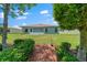 A serene backyard with a well-kept lawn and a cozy screened-in porch at 16193 Sw 14Th Avenue Rd, Ocala, FL 34473