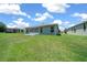 A well-manicured backyard featuring a green lawn and a screened-in patio at 16193 Sw 14Th Avenue Rd, Ocala, FL 34473
