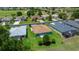 Aerial view of a backyard featuring healthy green grass and a screened patio at 16193 Sw 14Th Avenue Rd, Ocala, FL 34473
