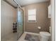 Clean bathroom with a tiled walk-in shower, window, and toilet; well-lit and functional at 16193 Sw 14Th Avenue Rd, Ocala, FL 34473