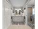 Bright bathroom with double sinks, tile flooring, and a glass-enclosed shower stall at 16193 Sw 14Th Avenue Rd, Ocala, FL 34473