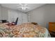 Spacious bedroom with a ceiling fan and large closet, featuring a patterned bedspread at 16193 Sw 14Th Avenue Rd, Ocala, FL 34473