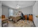 Cozy bedroom with a ceiling fan, neutral walls, and a comfortable bed with decorative pillows at 16193 Sw 14Th Avenue Rd, Ocala, FL 34473