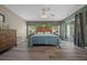 Bright bedroom with hardwood floors, a ceiling fan, and sliding glass doors leading to outdoor area at 16193 Sw 14Th Avenue Rd, Ocala, FL 34473