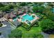 Aerial view of the community pool area, featuring a spacious pool, lounge chairs, and well-manicured landscaping at 16193 Sw 14Th Avenue Rd, Ocala, FL 34473