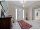 Inviting foyer featuring a white front door flanked by sidelights, colorful area rug, and decorative lighting at 16193 Sw 14Th Avenue Rd, Ocala, FL 34473