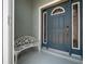 Stylish front door with decorative sidelights and transom window, plus a charming bench at 16193 Sw 14Th Avenue Rd, Ocala, FL 34473