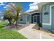 Welcoming front entrance with landscaped walkway, stone accents, and a screened entryway at 16193 Sw 14Th Avenue Rd, Ocala, FL 34473