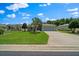 Beautiful one-story home featuring manicured lawn and a concrete driveway leading to a garage at 16193 Sw 14Th Avenue Rd, Ocala, FL 34473