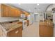 Kitchen area with granite counters, wood cabinets, and white appliances at 16193 Sw 14Th Avenue Rd, Ocala, FL 34473