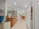 Open kitchen with tiled floor, granite counters, wood cabinets, and modern white refrigerator at 16193 Sw 14Th Avenue Rd, Ocala, FL 34473