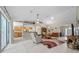 Spacious living room with tile floors, ceiling fan, and an open layout leading to the kitchen at 16193 Sw 14Th Avenue Rd, Ocala, FL 34473