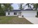 Charming single-story home with a well-manicured lawn and attached two-car garage at 17685 Sw 112Th Ln, Dunnellon, FL 34432
