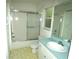 Bright bathroom featuring a bathtub with sliding door, toilet, and vanity with sink and large mirror at 19026 Sw 100Th Pl, Dunnellon, FL 34432