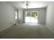 Large bedroom with ceiling fan and sliding glass doors that offers ample natural light at 19026 Sw 100Th Pl, Dunnellon, FL 34432