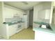 Bright kitchen with white cabinetry, laminate countertops, and essential appliances at 19026 Sw 100Th Pl, Dunnellon, FL 34432