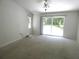 Spacious bedroom featuring a ceiling fan, sliding glass doors, and a large window at 19026 Sw 100Th Pl, Dunnellon, FL 34432