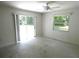 Bright main bedroom with ceiling fan and large glass slider allowing natural light at 19026 Sw 100Th Pl, Dunnellon, FL 34432