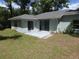 Patio with access via sliding glass doors and black awning at 19026 Sw 100Th Pl, Dunnellon, FL 34432