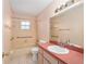 Cozy bathroom features a tub/shower combo, updated fixtures, and white tiled floors at 21 Pine Trace Run, Ocala, FL 34472