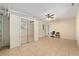 Spacious bonus room offers versatile space with mirrored closet doors and a ceiling fan at 21 Pine Trace Run, Ocala, FL 34472
