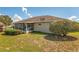 Back exterior of home with screened patio and well maintained lawn at 21 Pine Trace Run, Ocala, FL 34472