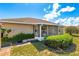 Rear view of house with screened in patio and manicured landscaping at 21 Pine Trace Run, Ocala, FL 34472
