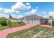 Front exterior of home with an attached carport and vibrant landscaping at 21 Pine Trace Run, Ocala, FL 34472
