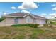Well-kept single-story home featuring a cozy front patio and manicured landscaping at 21 Pine Trace Run, Ocala, FL 34472